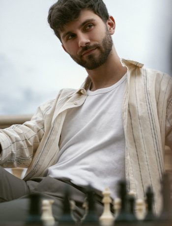 portrait-brothers-playing-chess-together-outdoors